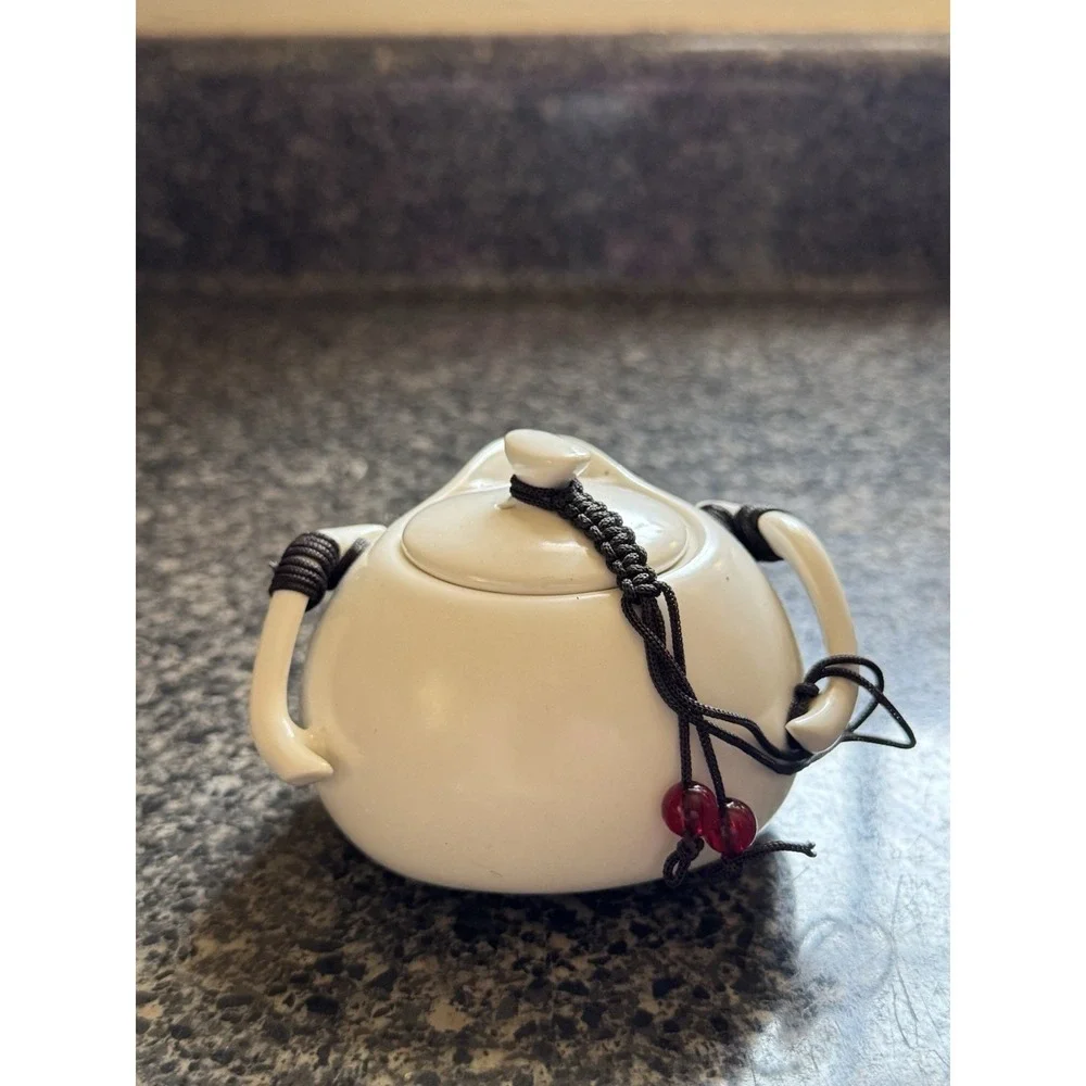 Compact travel tea pot white ceramic with decorative cord
